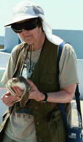 Picture of my mother Winnie holding a turtle in Grand Cayman